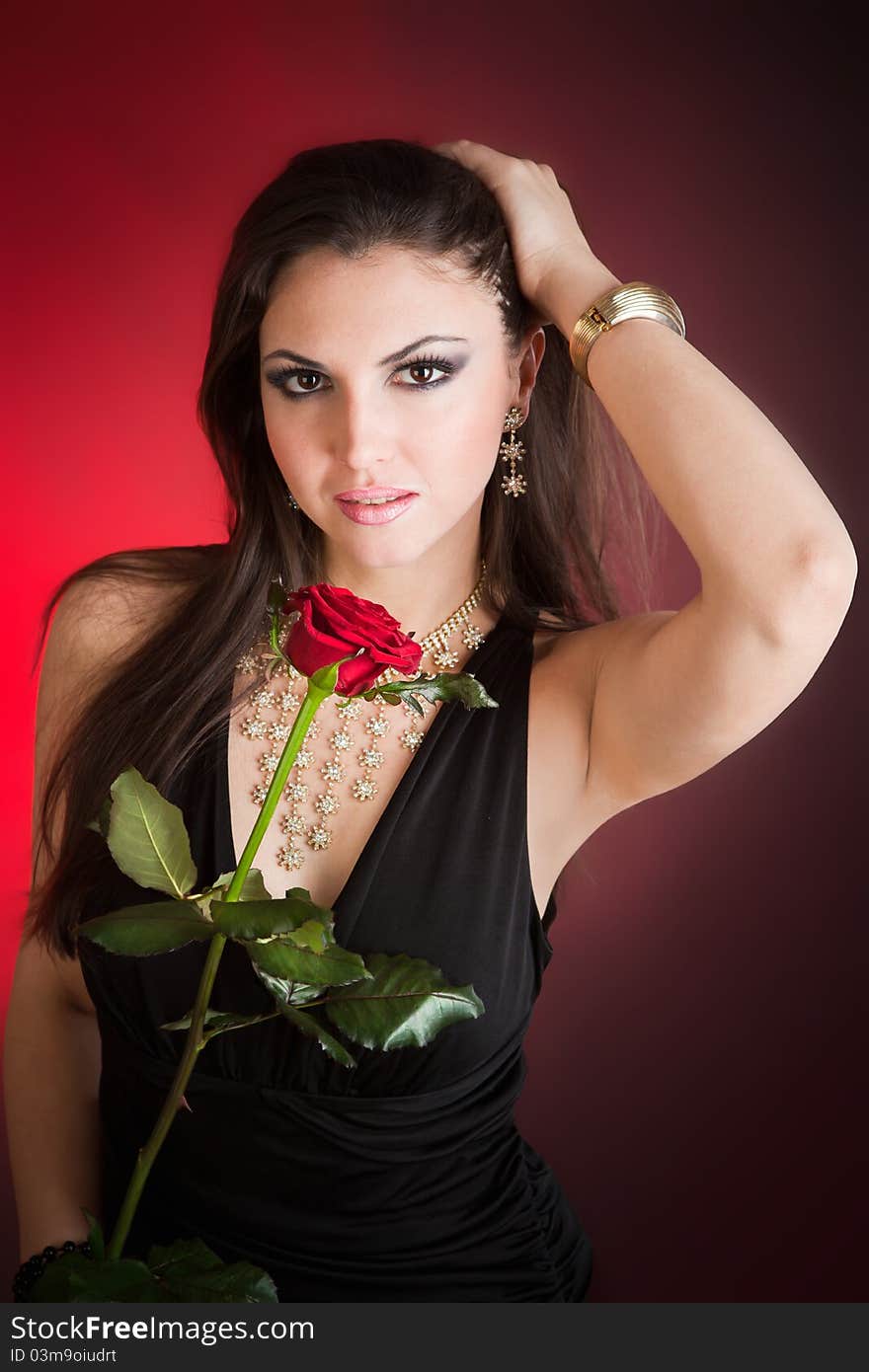 Portrait of young beautiful woman and red rose