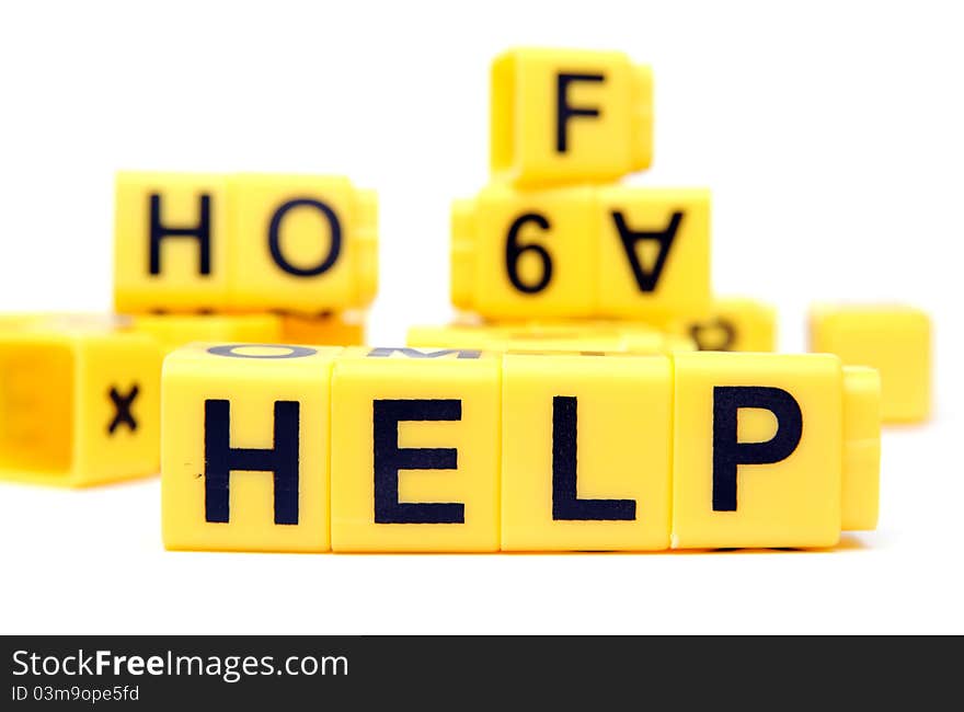 An image of yellow bricks with word ''help'' on them