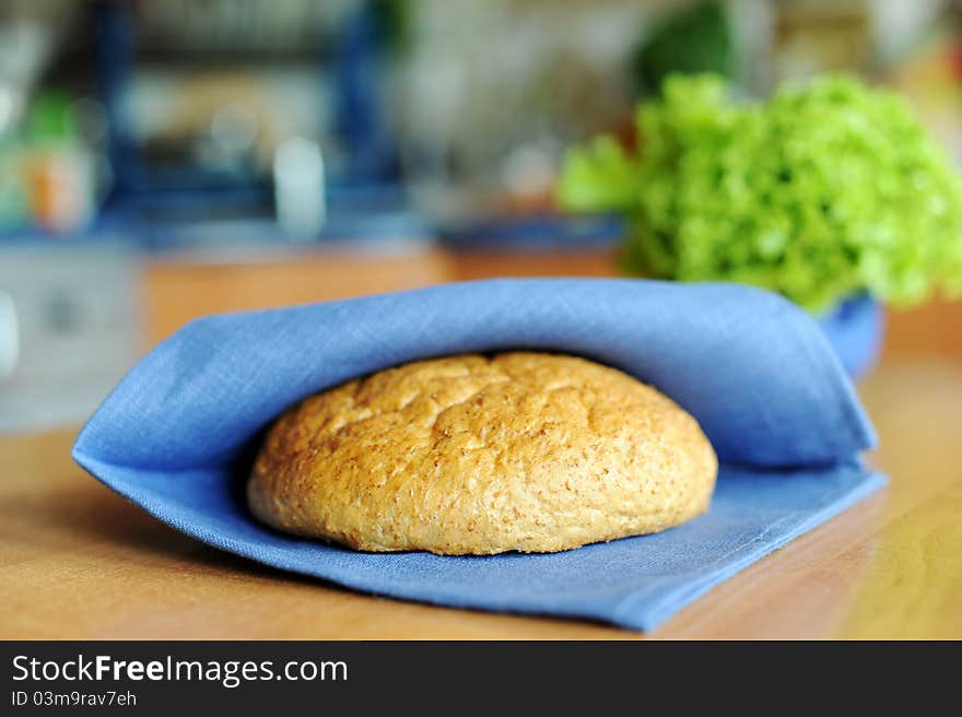 An image of a loaf of fresh bread on a napkin