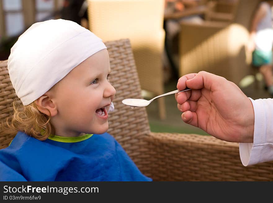 Baby is eating and smiling. Baby is eating and smiling