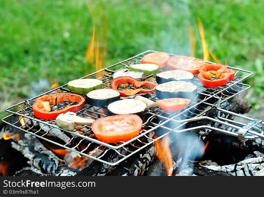 An image of a grill with vegetables on it. An image of a grill with vegetables on it