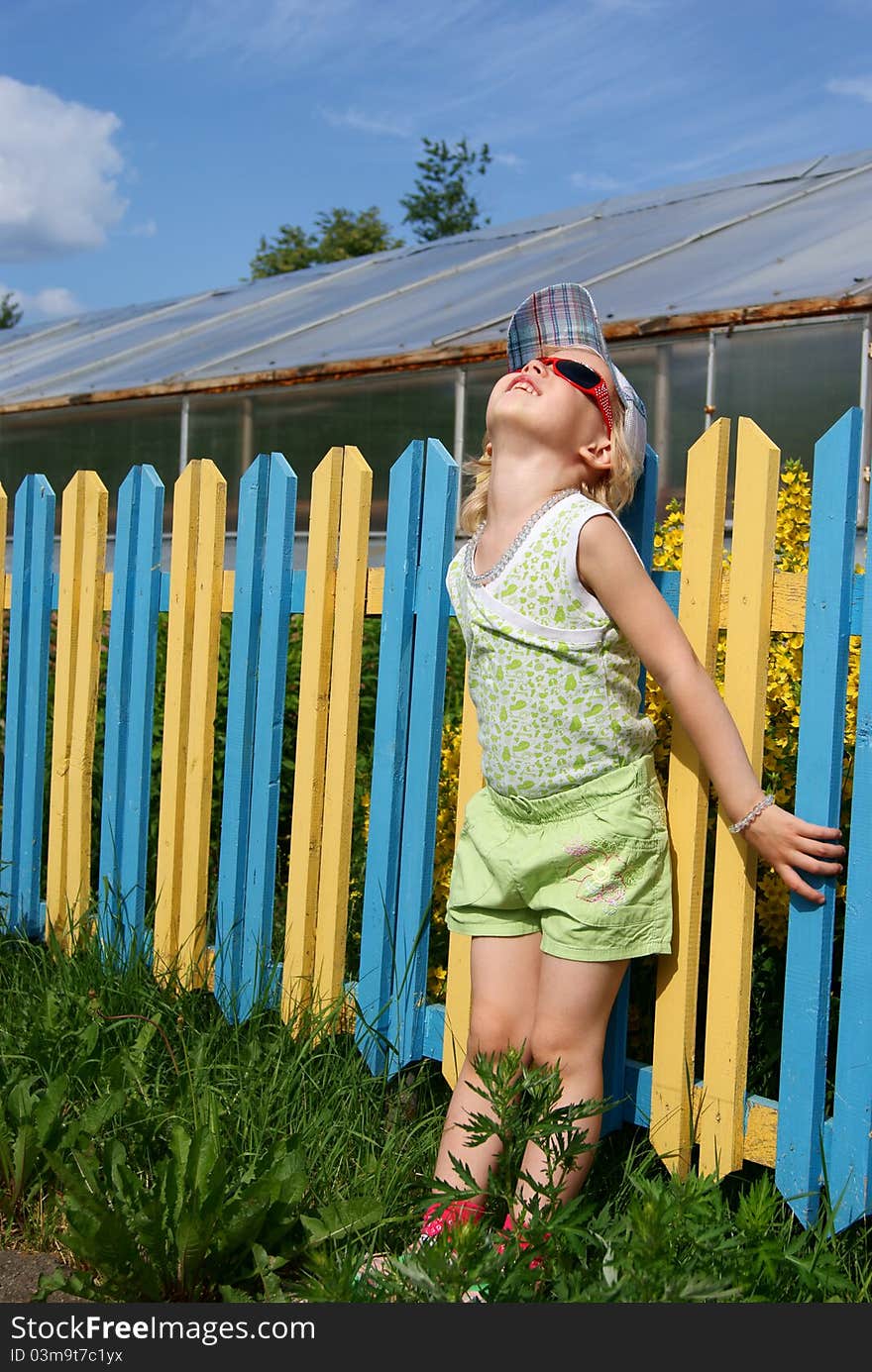 Girl near a colour fence