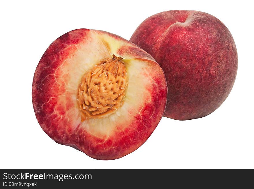 Deep-red peaches isolated on white one of them cut in half