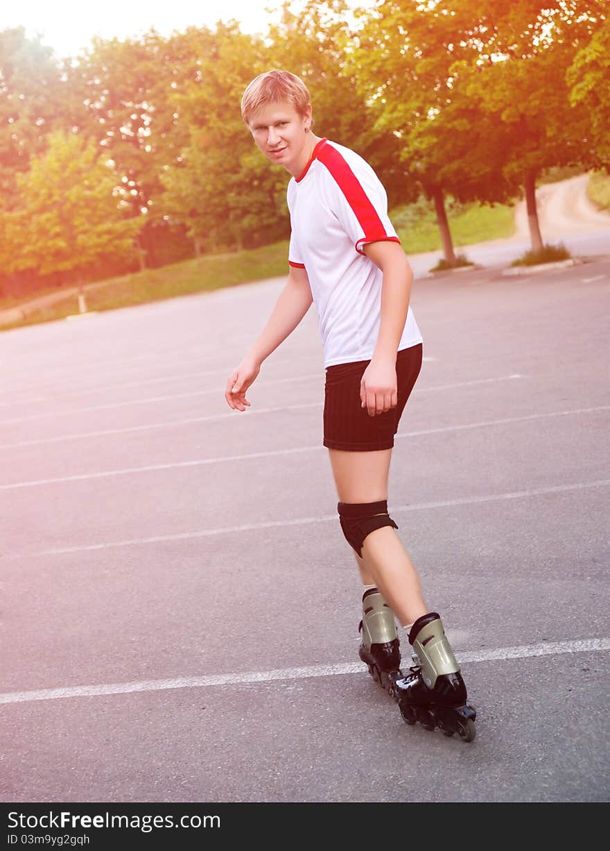 Young active roller blade skater on the park