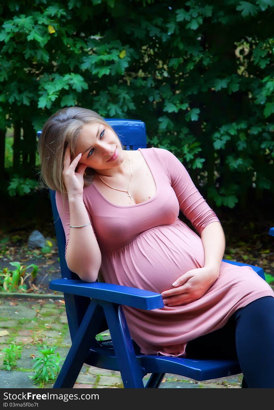 Pregnant woman waiting in garden