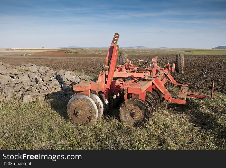 Disk Ripper in the field. Plough is a tool used in farming for in initial cultivation of soil