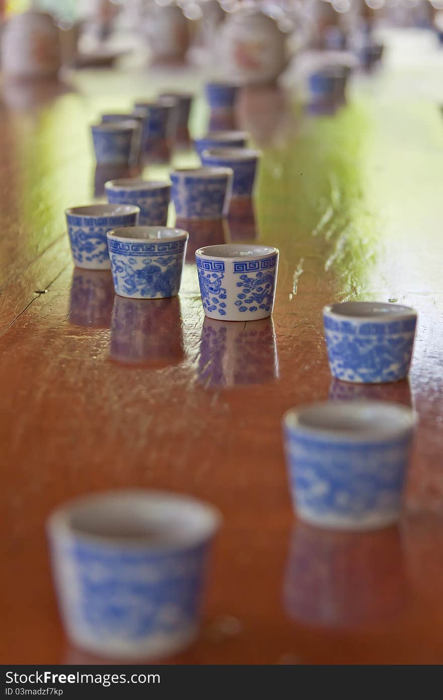 Cups and teapots on a table after a tea ceremony outdoors. Cups and teapots on a table after a tea ceremony outdoors