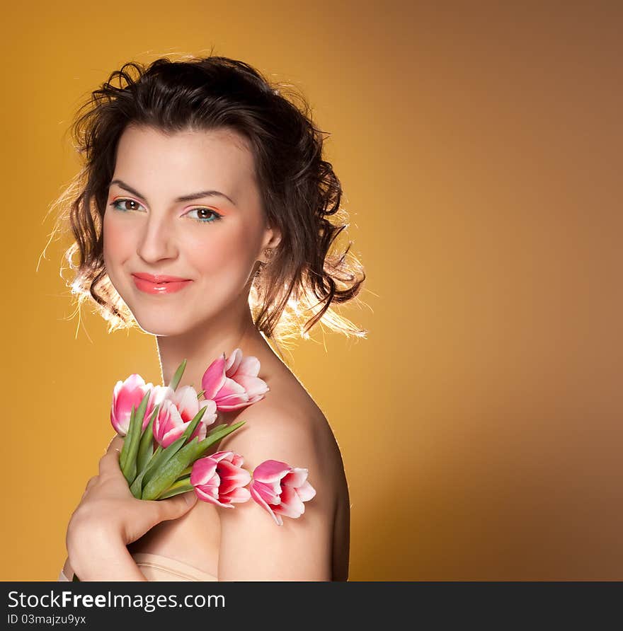 Portrait of a beautiful girl with a tulips