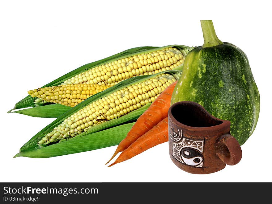 Fresh vegetables from a bed and clay mug. Fresh vegetables from a bed and clay mug.