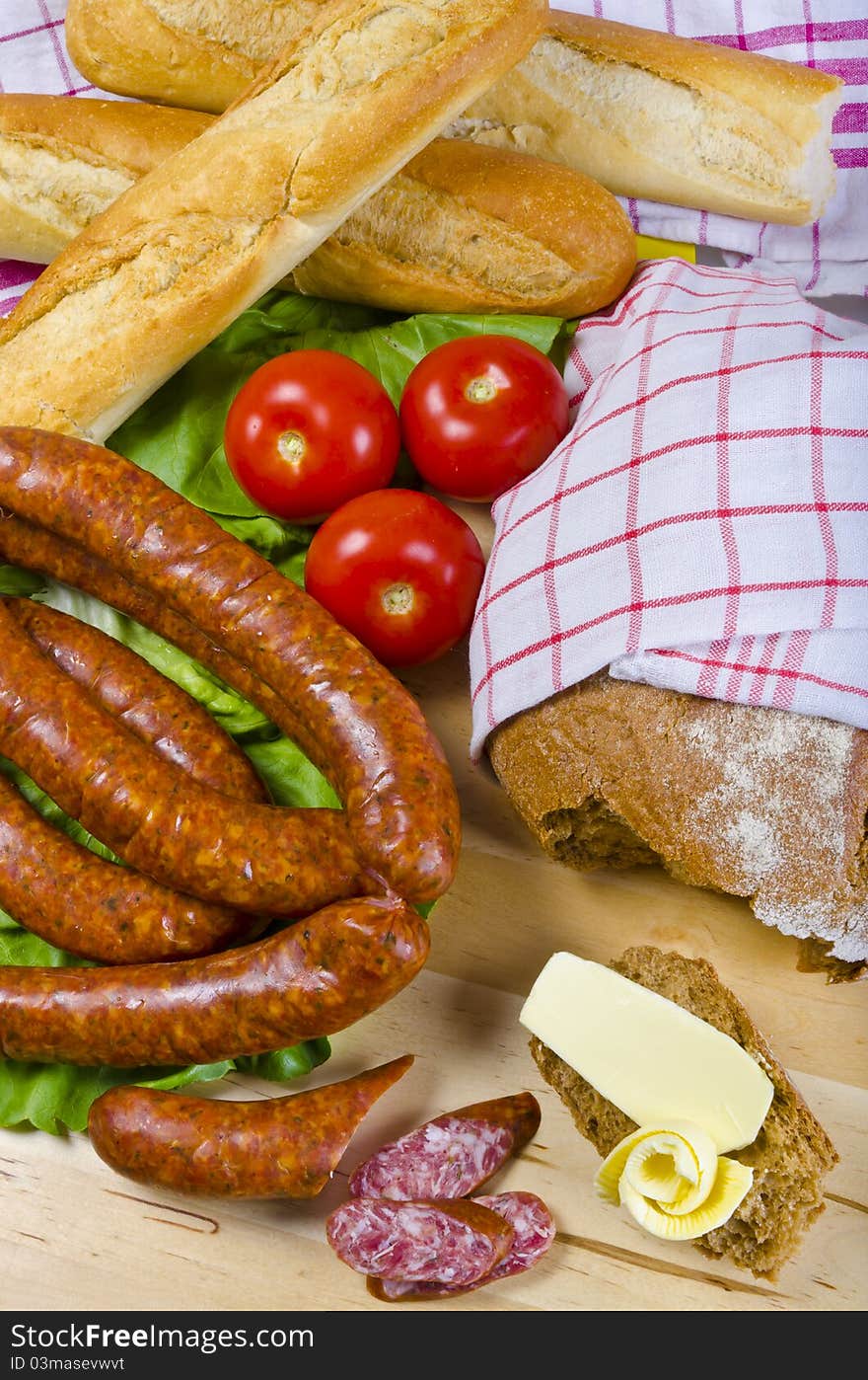 Tasty Polish sausage with bread, butter and vegetables