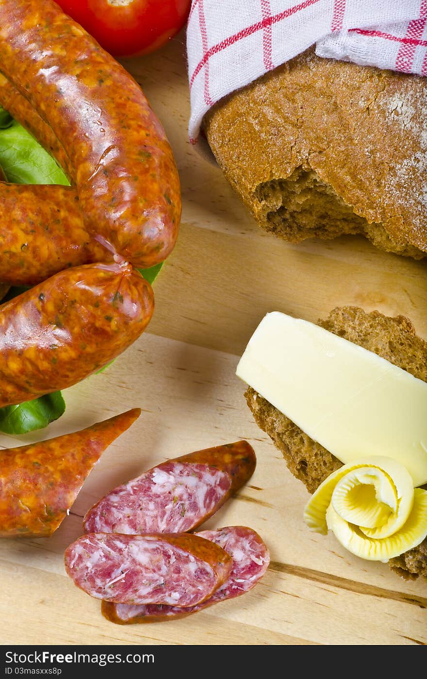 Tasty Polish sausage with bread, butter and vegetables