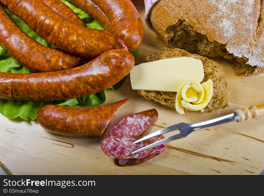 Tasty Polish sausage with bread, butter and vegetables