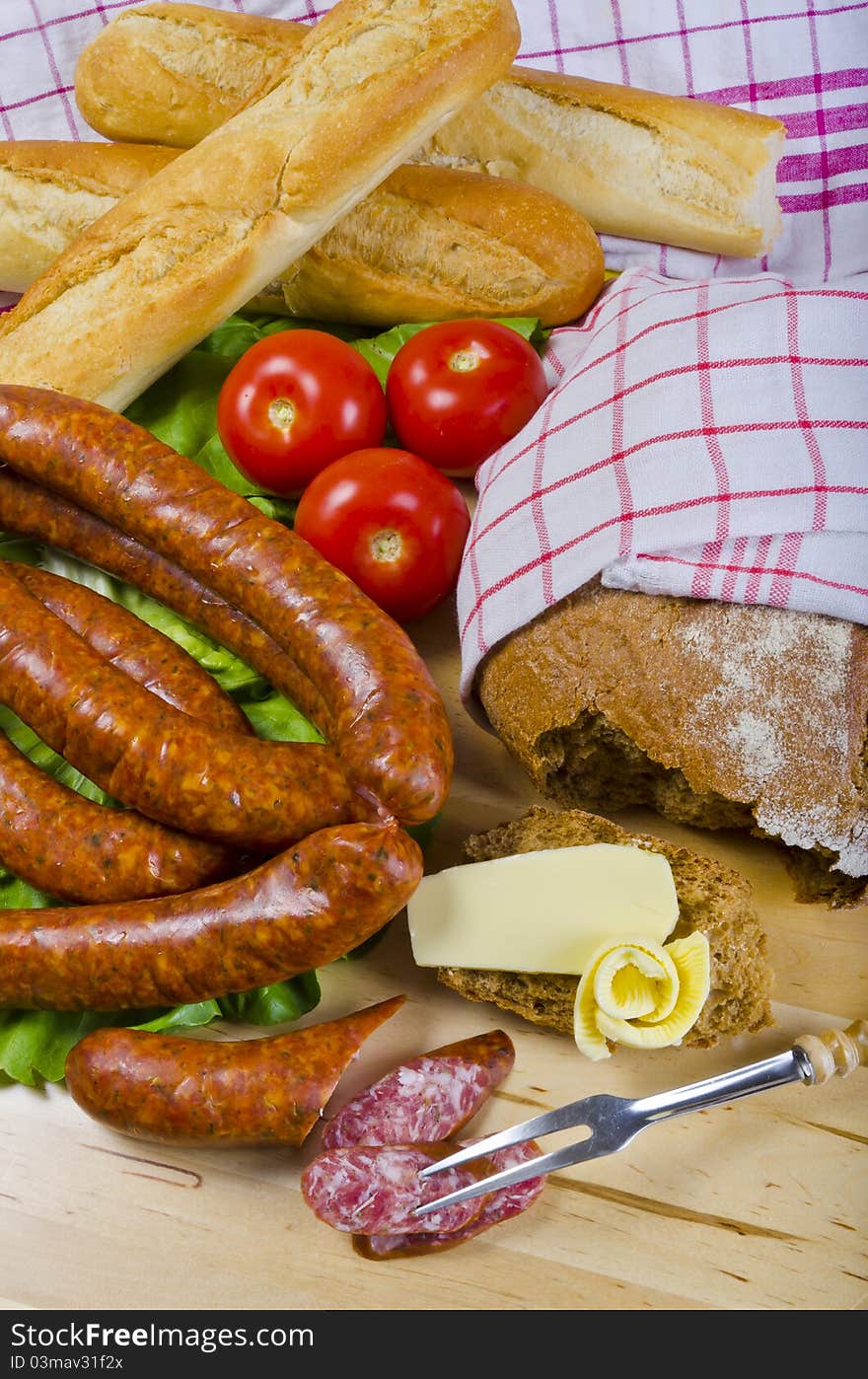 Tasty Polish sausage with bread, butter and vegetables