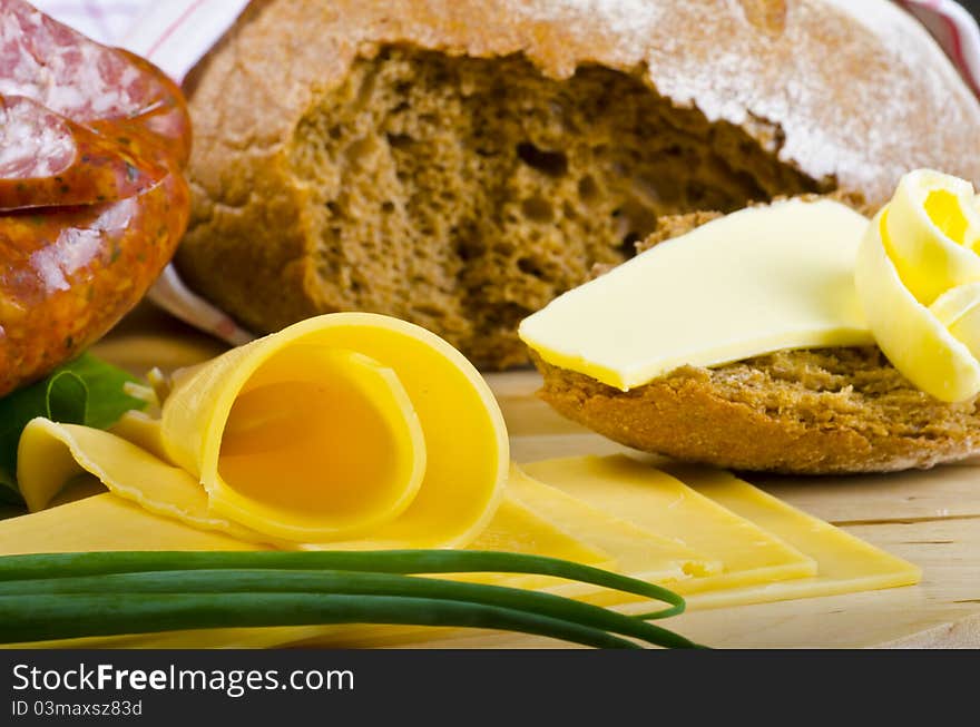 Tasty Polish sausage with bread, butter and vegetables