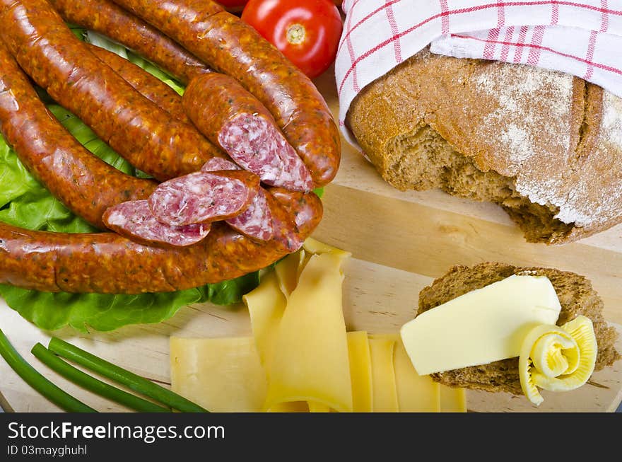 Tasty Polish sausage with bread, butter and vegetables