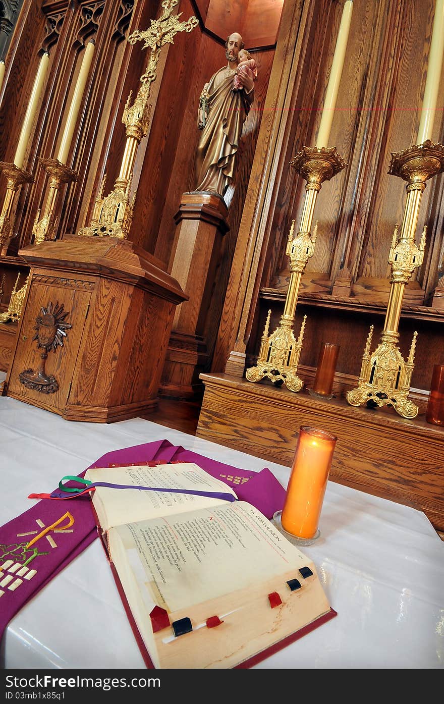 Catholic altar in church interior. Open Bible in foreground. Catholic altar in church interior. Open Bible in foreground.