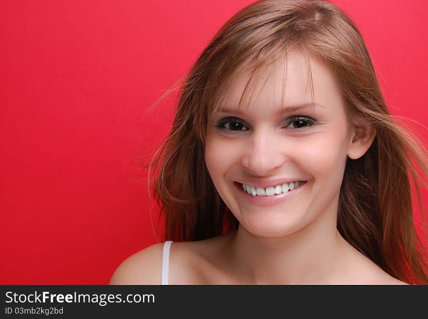 Portrait of a young woman on red