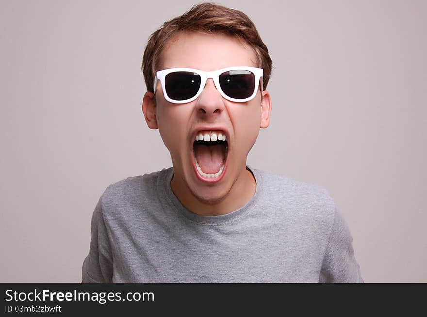 Portrait of a young man on gray