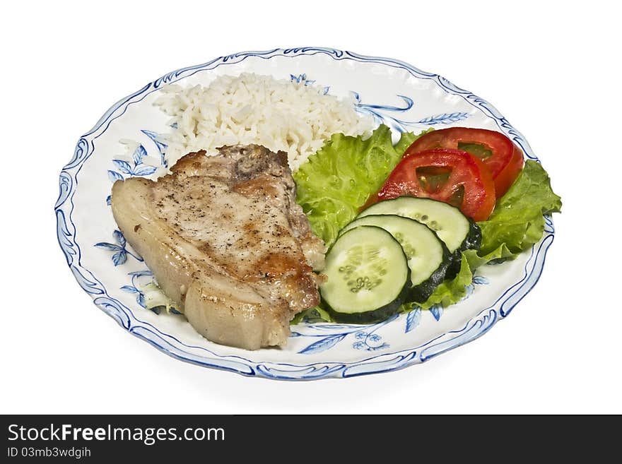 Meat with vegetables and rice on white plate