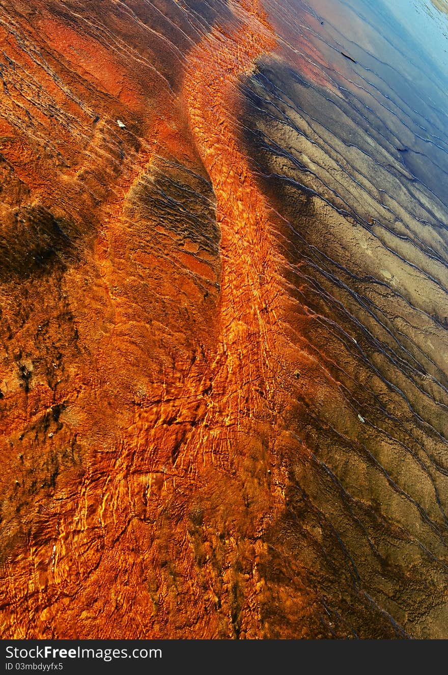 Abstract photograph of Grand Prismatic in Yellowstone National Park. The ground here is covered with water which runs off from the thermal area. The color changes in the land are caused by different types of sediments and minerals. Abstract photograph of Grand Prismatic in Yellowstone National Park. The ground here is covered with water which runs off from the thermal area. The color changes in the land are caused by different types of sediments and minerals.