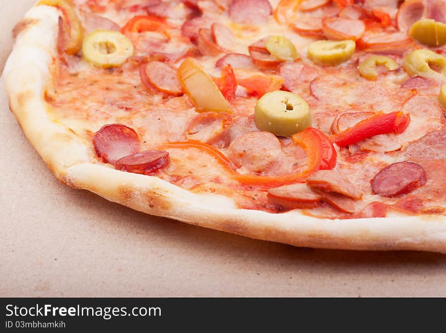 Hot and delicious pizza with meat and vegetables.