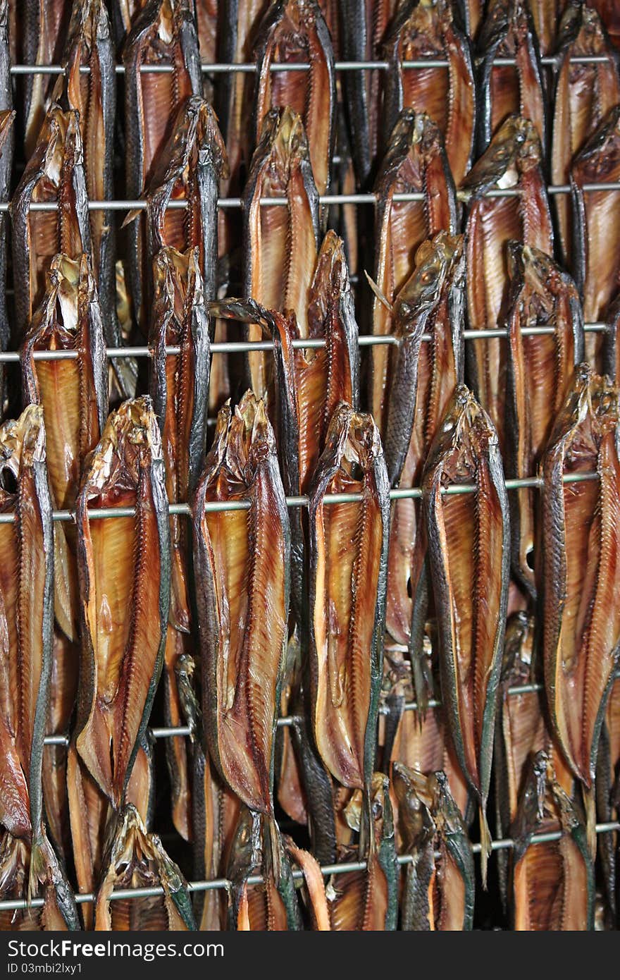 Freshly Smoked Kippers Hanging in a Smoking Cabinet. Freshly Smoked Kippers Hanging in a Smoking Cabinet.