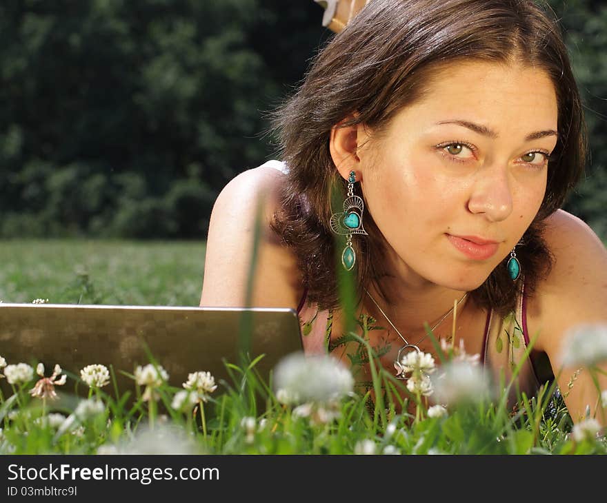 The image of a girl lies on a grass