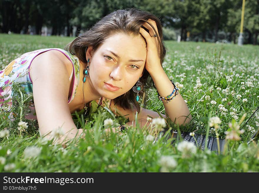 The image of a girl lies on a grass