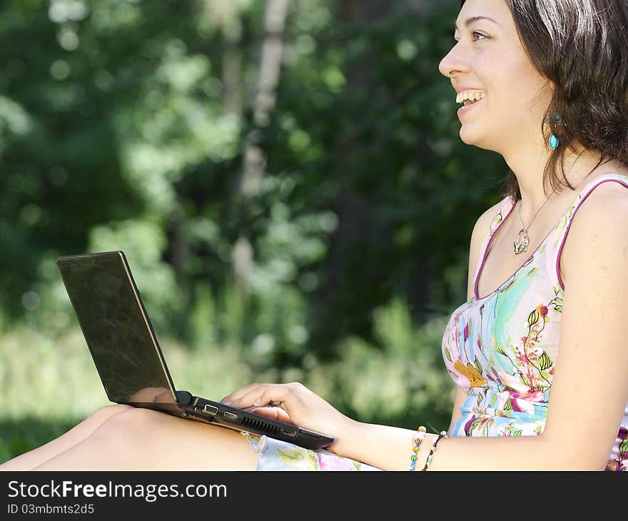 The image of a girl sits on a grass