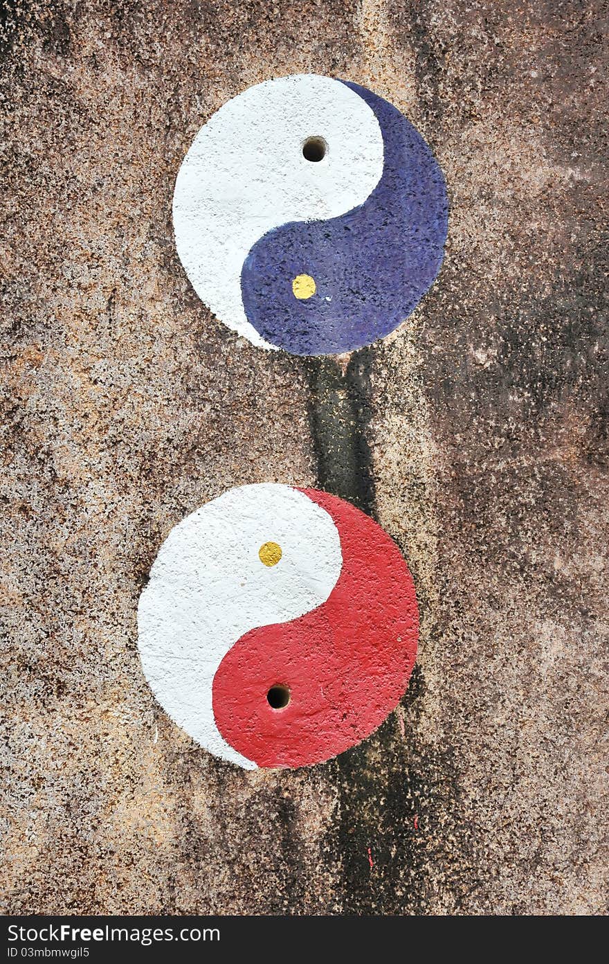 Yin Yang Symbols Drawn On A Rock Surface