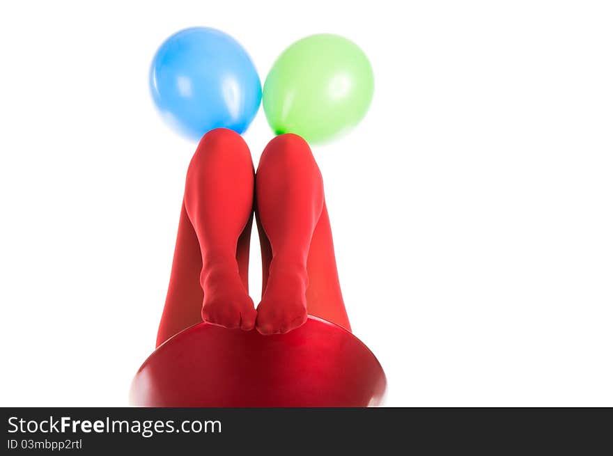 Female feet in red stockings with balloons isolated in white