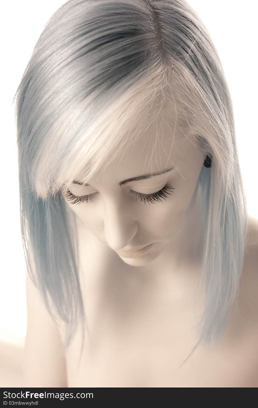 Close-up of a teen girl with long eye lashes looking down shot in infra red