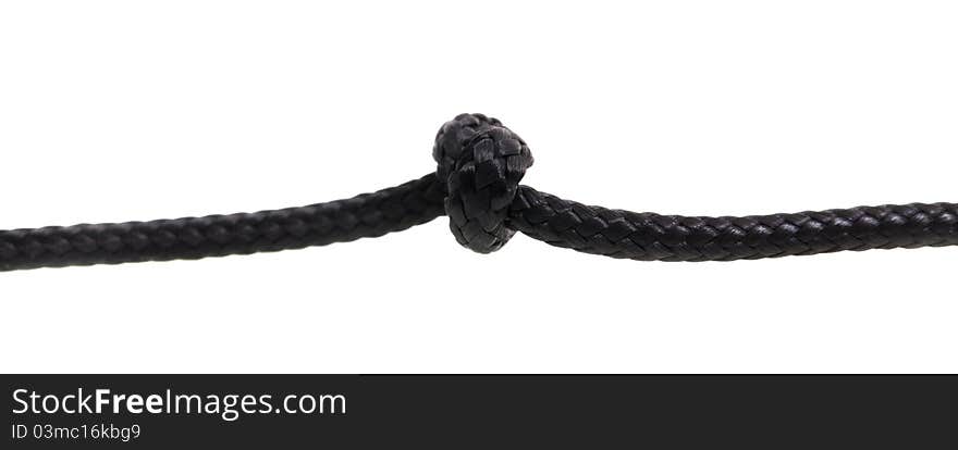 The knot fastened on a thin rope (macro a photo, isolated). The knot fastened on a thin rope (macro a photo, isolated)