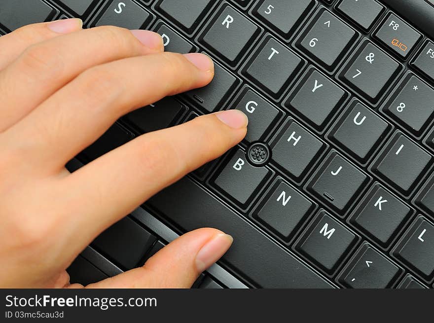 Closeup of male fingers pressing on black alphabet keys. Closeup of male fingers pressing on black alphabet keys.