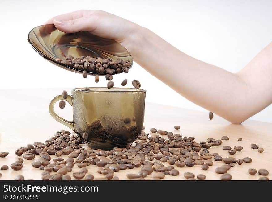 Hands pours coffee into a coffee cup