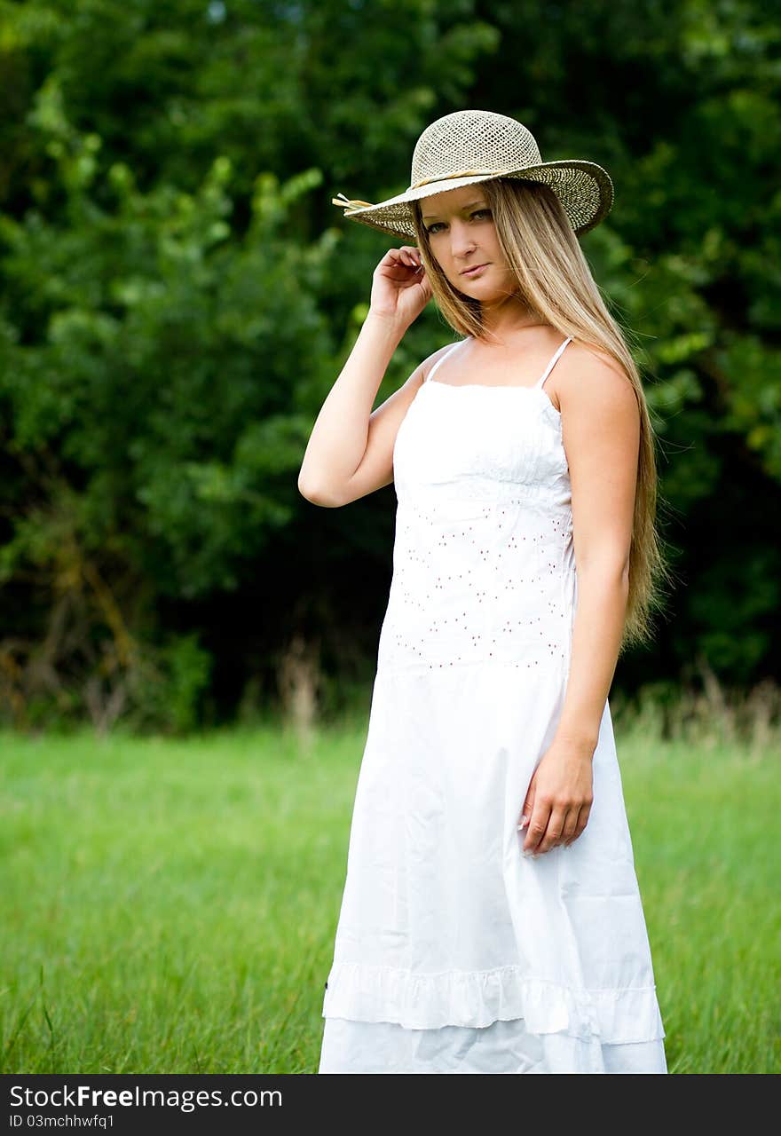 Young beautiful girl in straw hat