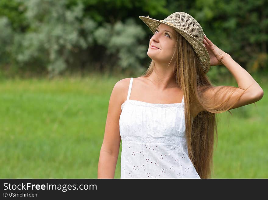 Young beautiful girl in straw hat