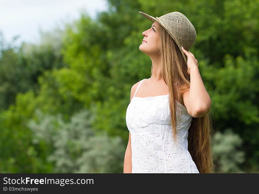 Young beautiful girl in straw hat