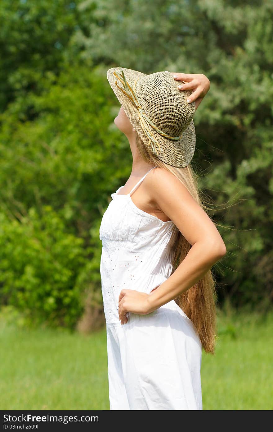 Young beautiful girl in straw hat