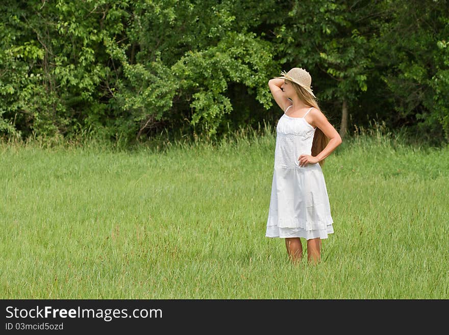 Young beautiful girl in straw hat