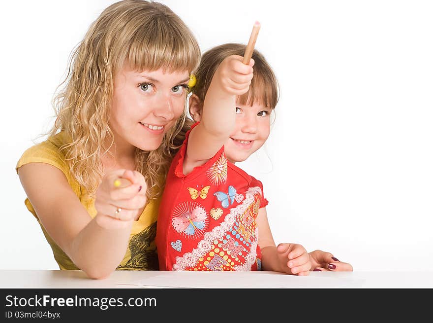 Happy mom and daughter drawing at table