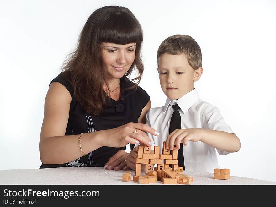 Mom and her son playing at the table. Mom and her son playing at the table