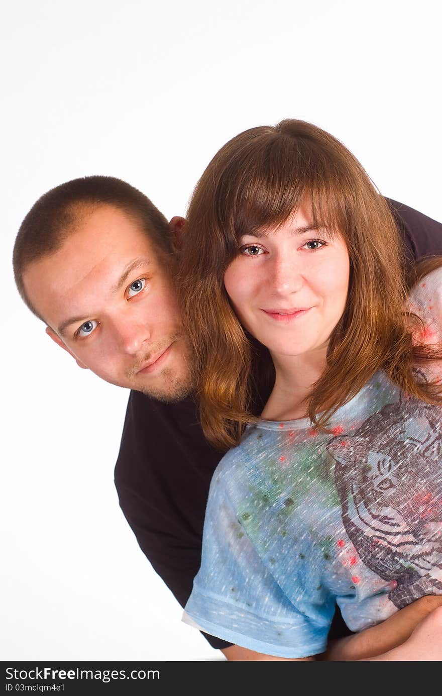 Happy cute couple posing on a white