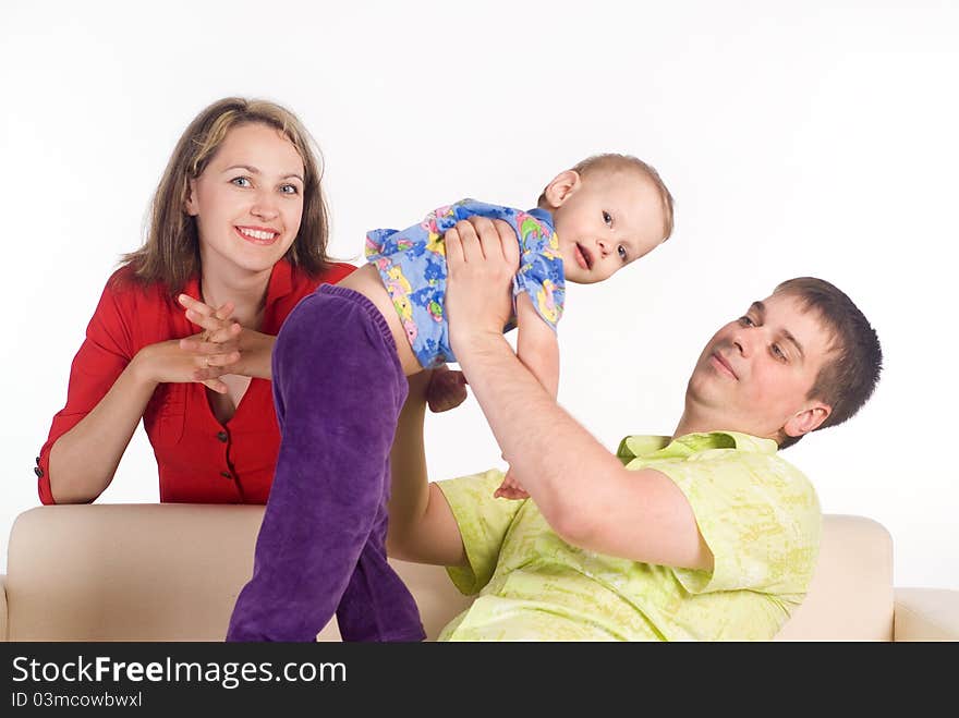 Pretty family on a sofa on a white. Pretty family on a sofa on a white