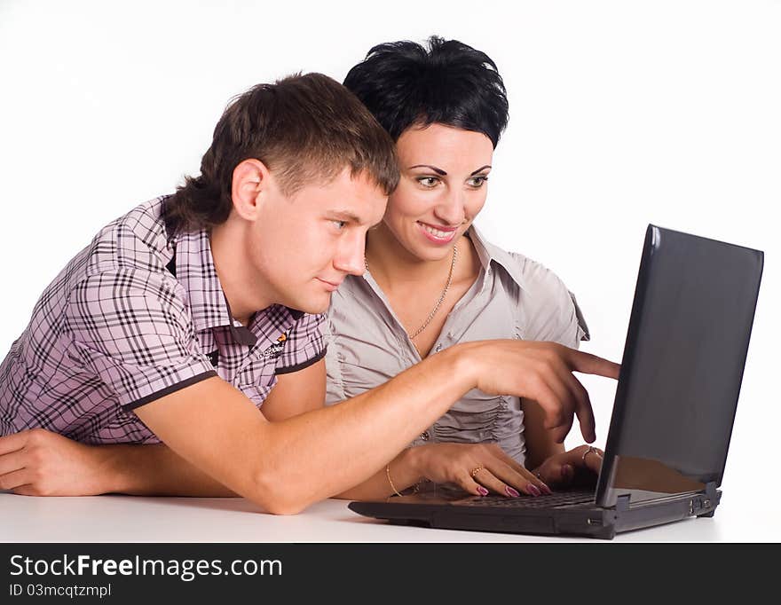 Young couple with a laptop on a white. Young couple with a laptop on a white