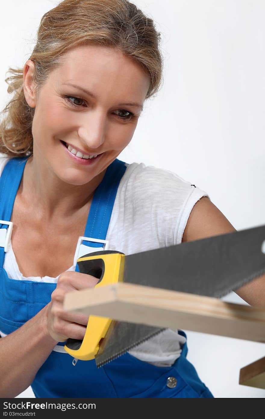 Woman Sawing A Plank