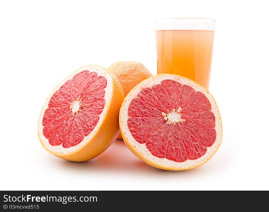 Ripe grapefruit and a glass of juice isolated on white background