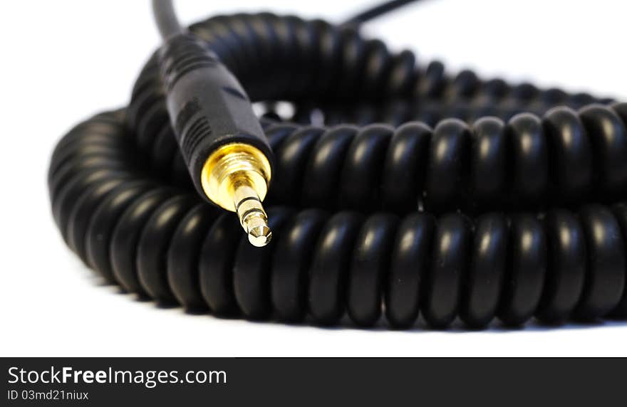 Black cable with golden plug. macro. Black cable with golden plug. macro