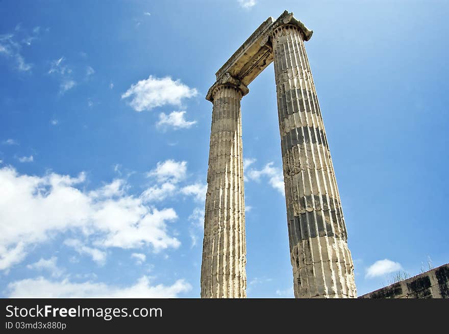 Ancient ruins of a temple, just two columns against a blue sky. Ancient ruins of a temple, just two columns against a blue sky