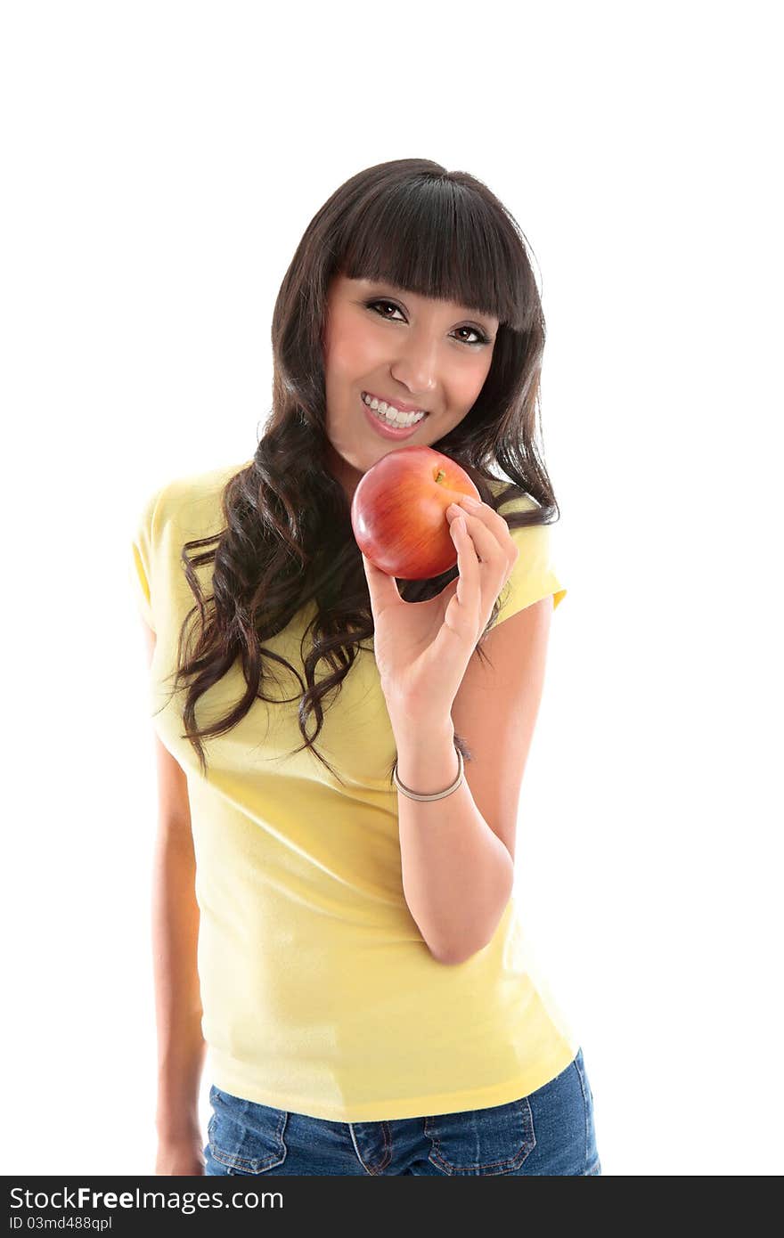 Attractive smiling woman eating a healthy choice food snack. She is holding a ripe red apple in her left hand. Attractive smiling woman eating a healthy choice food snack. She is holding a ripe red apple in her left hand.